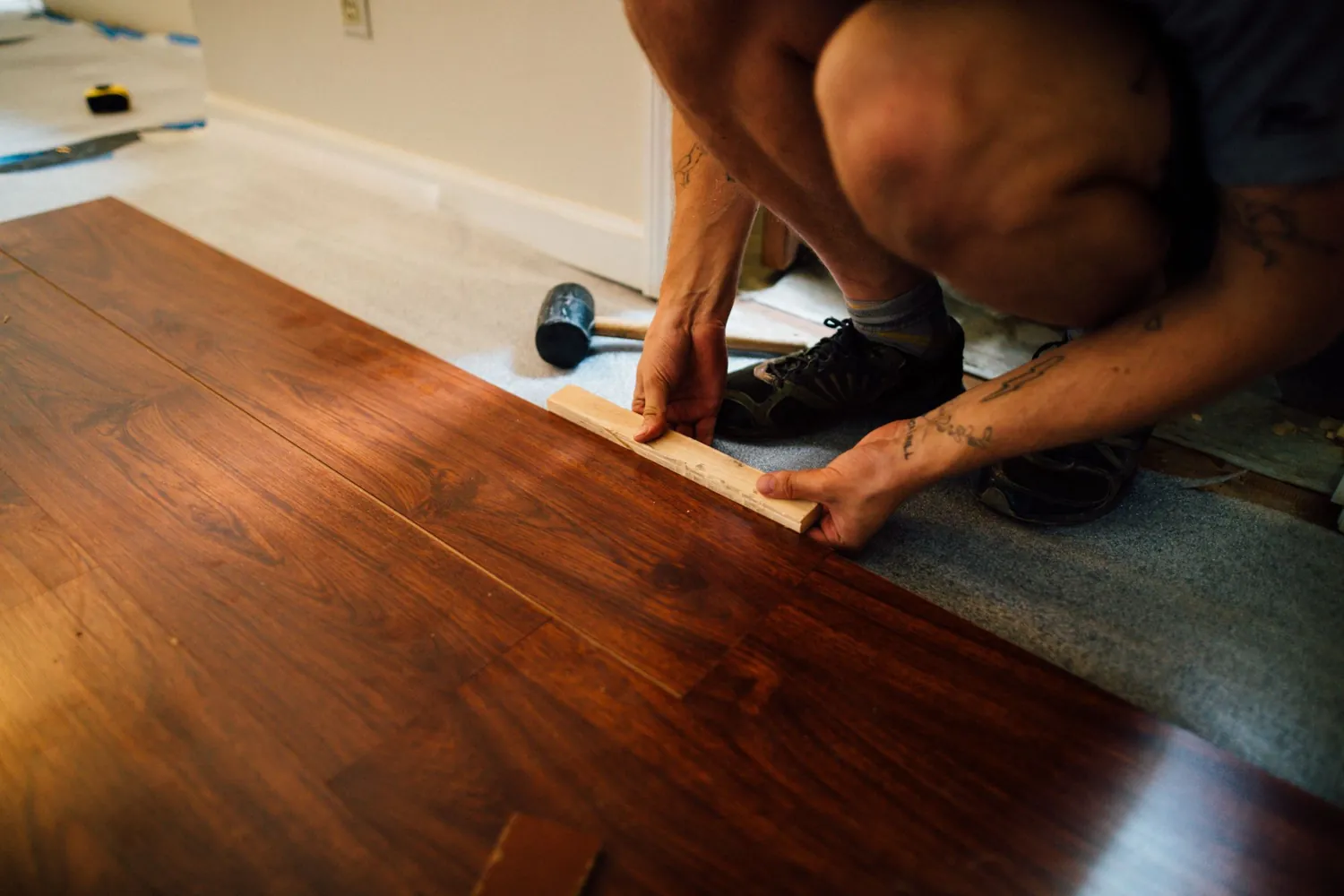Laminate flooring planks being fitted together on a floor